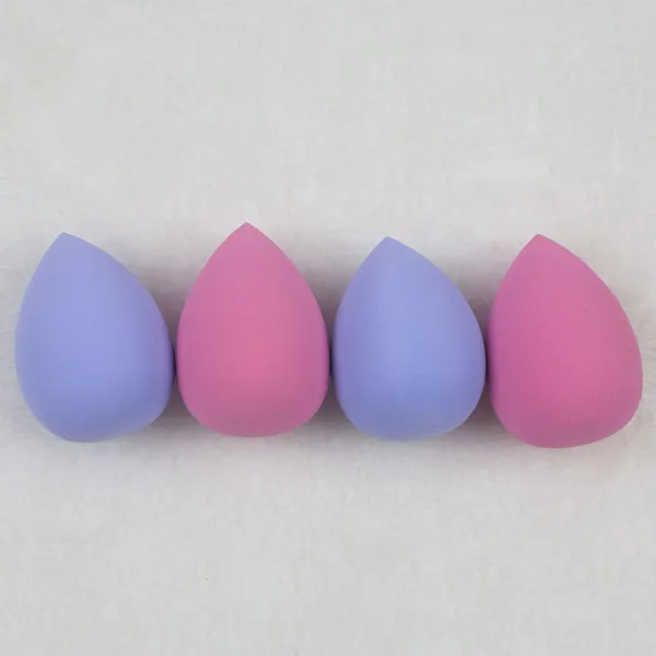 Vegan beauty blender sponges in pink and purple displayed in a PET box